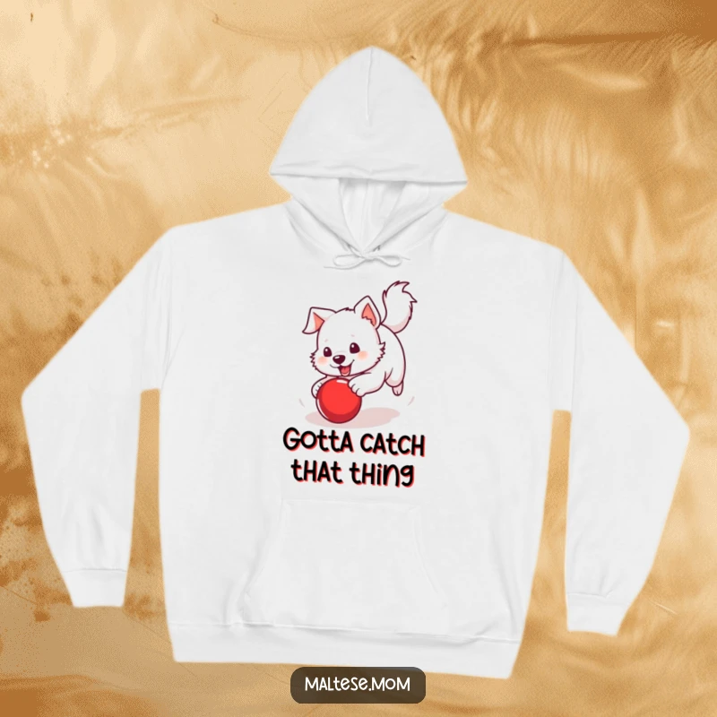 Funny Hoodie portraying a white dog with a perky tail chasing a bright red ball, symbolizing energy and fun.
