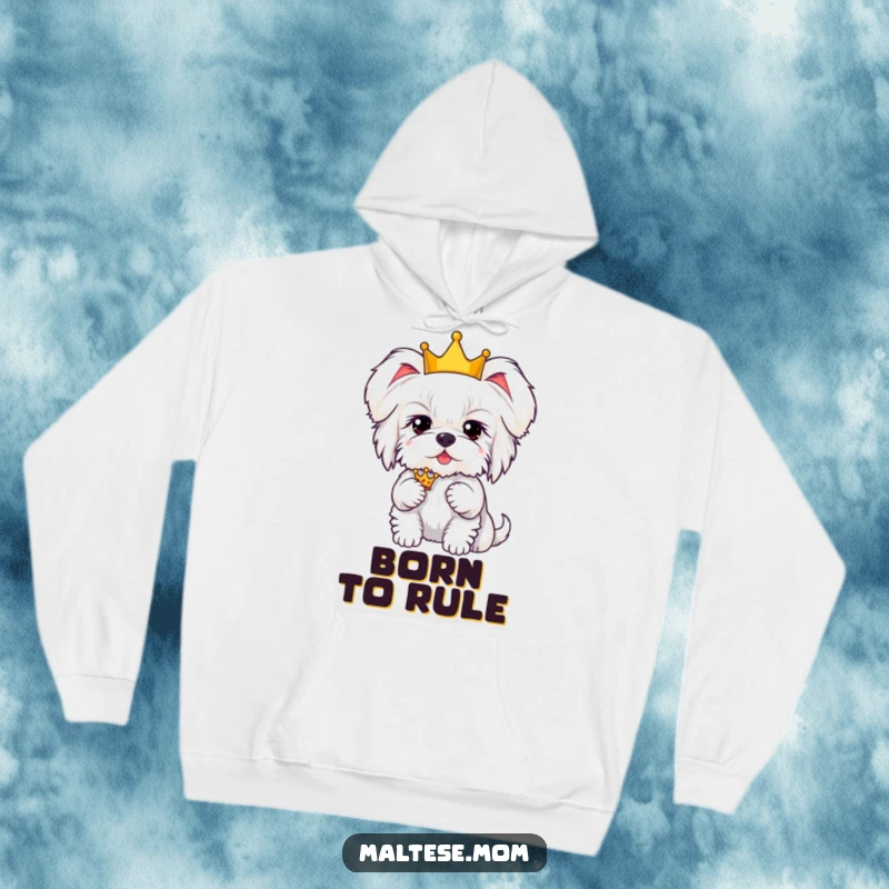 Funny Kawaii Maltese dog with fluffy ears, wearing a crown, exuding hilarious royal charm in a cozy hoodie.