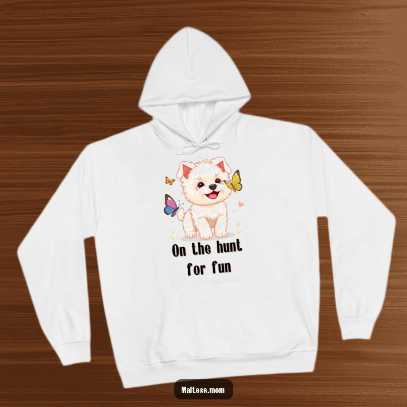 Funny hoodie featuring a smiling Maltese puppy enthusiastically chasing a butterfly, designed for warmth and adorable smiles.