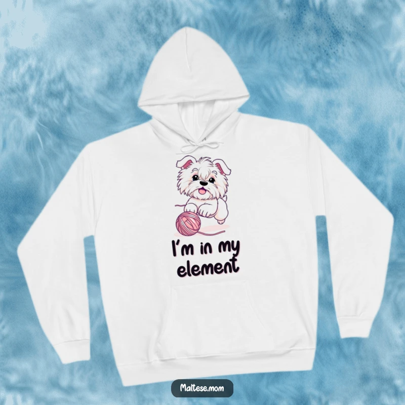 Funny Maltese dog hoodie with a cute, energetic character gleefully chasing a rolling yarn ball, perfect for casual wear and expressing playful joy.