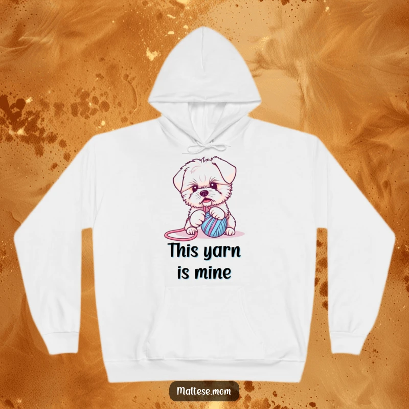 Funny Maltese puppy hoodie: a charming dog playfully wrestling with a ball of yarn, designed for ultimate comfort and humorous style.