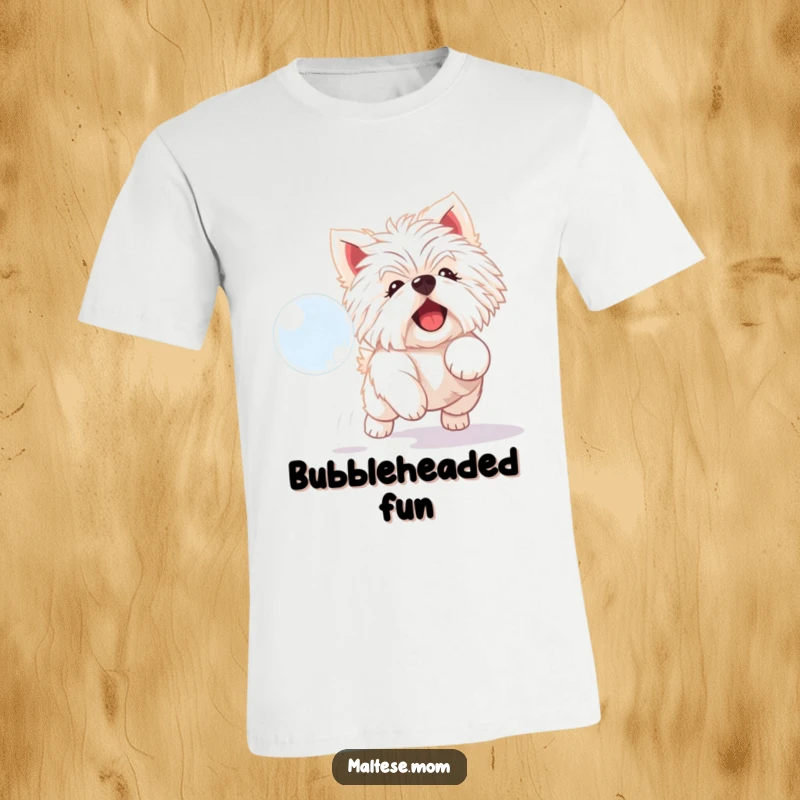 Funny Maltese dog t-shirt of a playful white dog with a delighted expression, chasing a shimmering bubble.