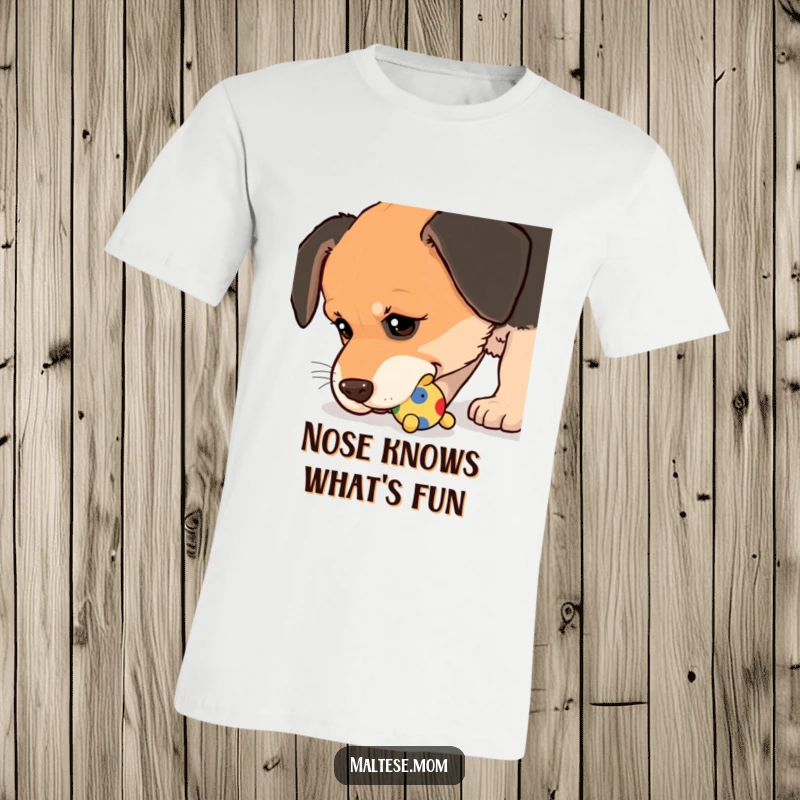 Funny T-Shirt of a dog nudging a small, colorful toy with its wet nose, capturing a moment of playful curiosity.
