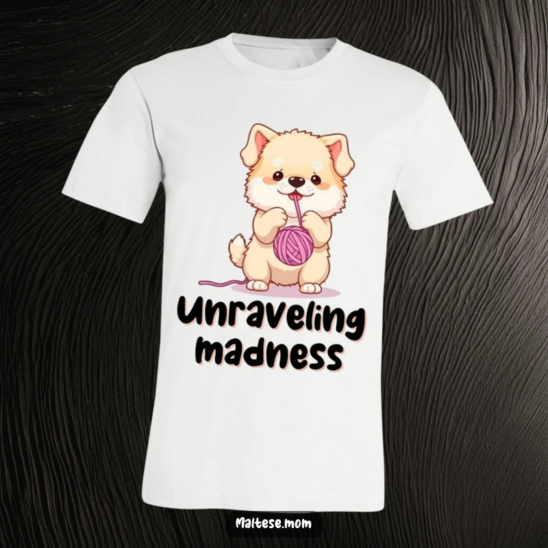Funny t-shirt with a small, fluffy dog character mid-play, enthusiastically batting at a dangling yarn ball, showcasing its fun-loving nature.