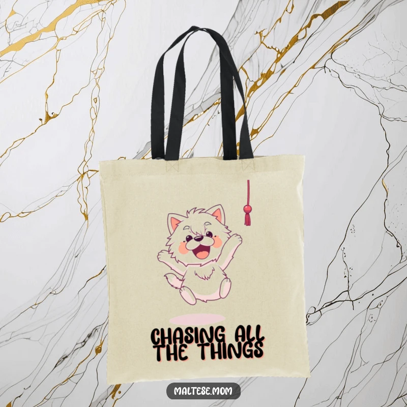 Funny Maltese tote bag showing an energetic Maltese dog leaping mid-air towards a dangling string, ready for playtime action.